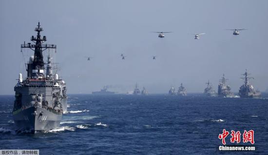 当地时间10月18日，日本海上自卫队在相模湾正式举行“观舰式”。图为日本海上自卫队“鞍马号”护卫舰(左前)。